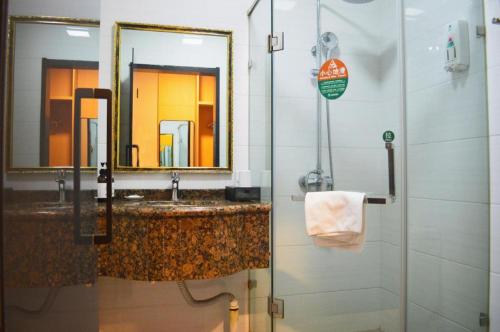 a bathroom with a sink and a mirror at GreenTree Inn Harbin Central Avenue in Harbin