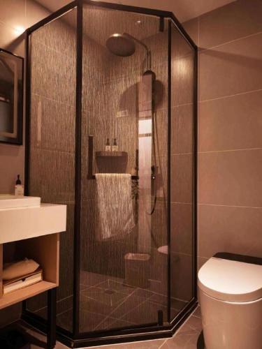 a glass shower in a bathroom with a toilet at GreenTree Inn Datong YundinGYAyuan Express Hotel in Datong
