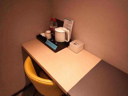 a desk with a coffee maker and a toaster on it at GreenTree Inn Datong YundinGYAyuan Express Hotel in Datong