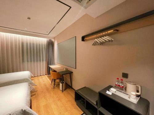 a hotel room with a bed and a desk at GreenTree Inn Datong YundinGYAyuan Express Hotel in Datong