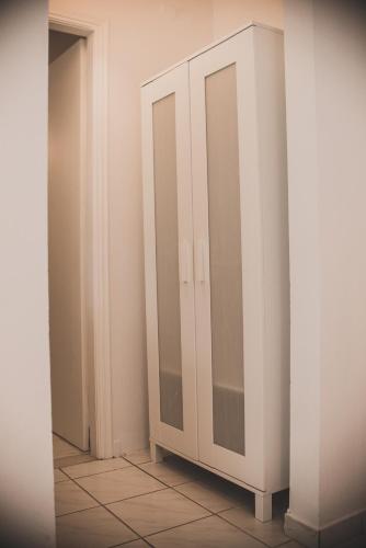 a white cabinet in a room with a mirror at Nerina Studios Agios Nikitas in Agios Nikitas
