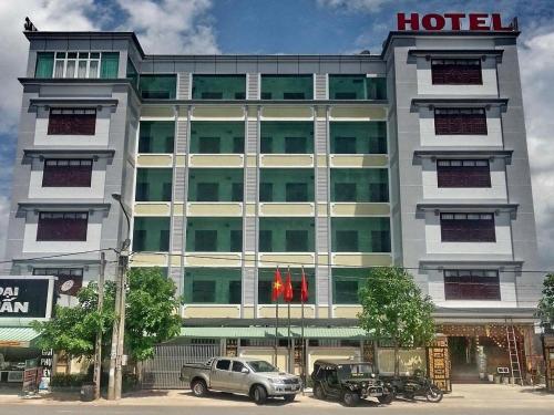 a hotel with cars parked in front of it at Au Lac Hotel in Thu Dau Mot