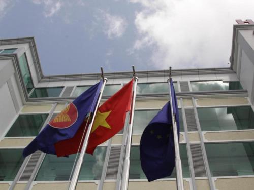 three flags flying in front of a building at Au Lac Hotel in Thu Dau Mot