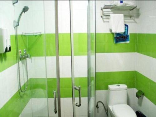 a green and white bathroom with a shower and a toilet at 7 Days Inn Guilin Beiji Plaza Yushan Garden in Guilin