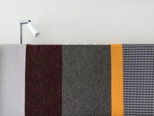 a towel hanging on a towel rack with a lamp at Hotel Edit Yokohama in Yokohama