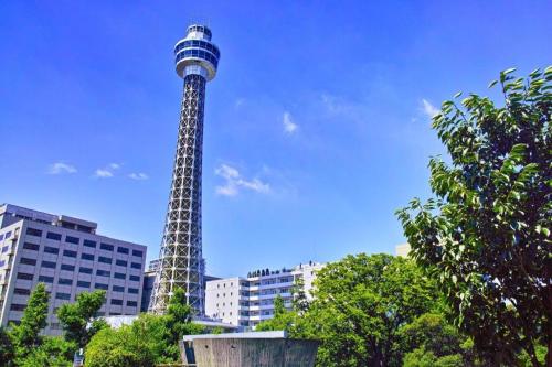 a tall tower in the middle of a city at Hotel Edit Yokohama in Yokohama