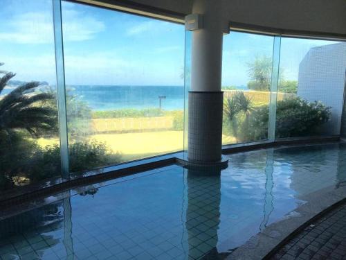 a swimming pool with a view of the ocean at Hotel Harvest Nankitanabe in Tanabe