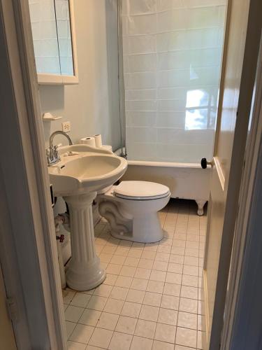 a bathroom with a white toilet and a sink at Walnut in Owings Mills