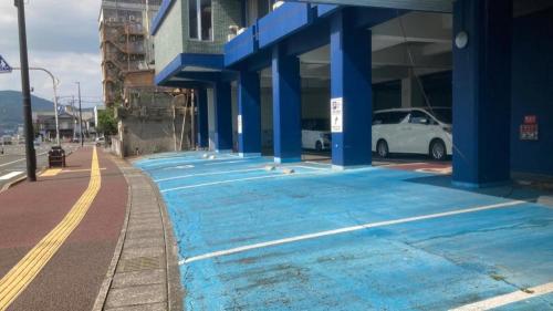 a blue painted sidewalk in front of a building at Hamakan Hotel in Unzen