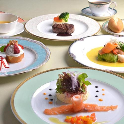a table with plates of food on it at Hamakan Hotel in Unzen