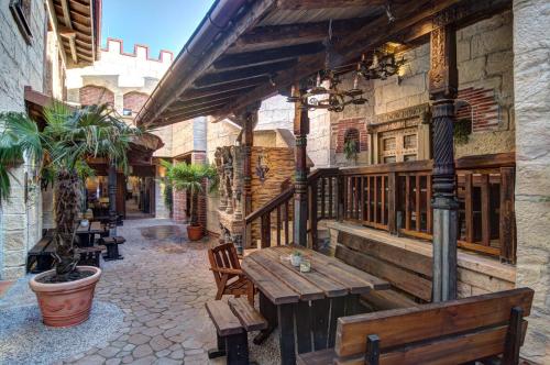 a patio with benches and tables on a building at Vaya Casa in Kappelrodeck