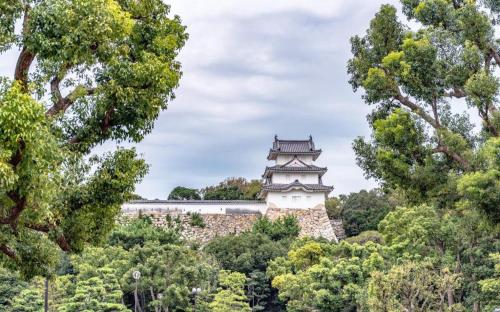a tower in a park with trees at Hotel Castle Plaza in Kobe