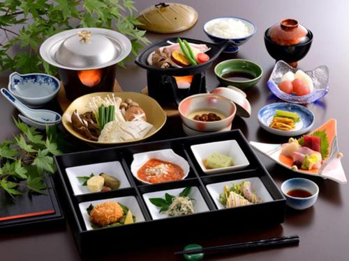 a table topped with plates of food and bowls of food at Yuzawa New Otani in Yuzawa