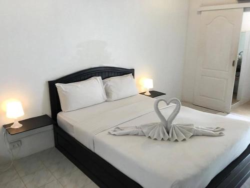 a bedroom with a bed with a heart decoration on it at SP. Place Hotel in Ko Chang