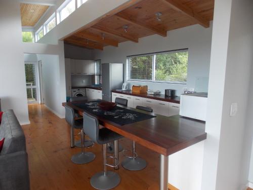 a kitchen with a large wooden island in a room at By the Sea Vacation Home in Brenton-on-Sea