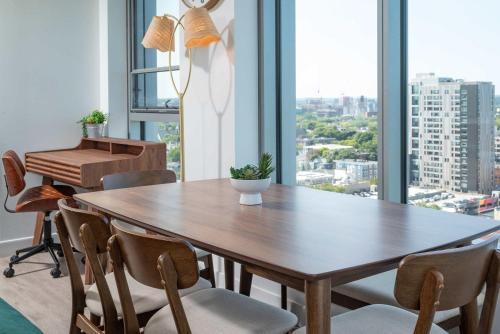 a dining room with a table and a piano at High Rise Retreat w City Skyline Views Shared Gym in Cambridge
