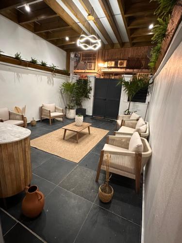 a living room with couches and tables and plants at moroco in Pointe-à-Pitre