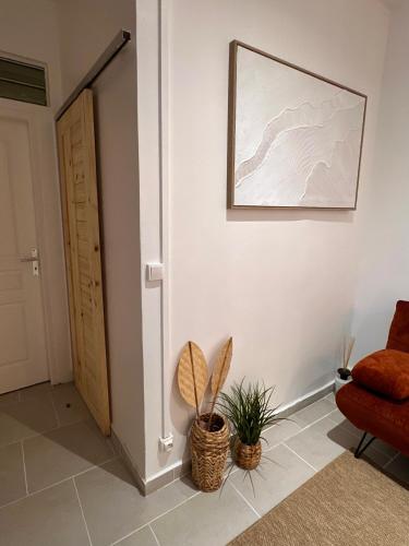 a living room with a chair and a picture on the wall at moroco in Pointe-à-Pitre