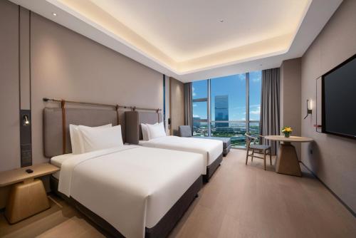 Postel nebo postele na pokoji v ubytování Holiday Inn Express Suzhou North Station by IHG