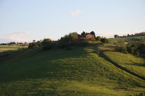a house sitting on top of a green hill at Country House Montesoffio in Barchi