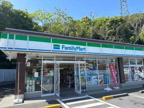 a familymart store with its doors open in a parking lot at LOG HOUSE 白浜 -Shirahama- Dog run, hot springs, BBQ, and sauna! PET OK in Shirahama