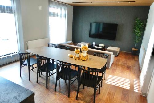 a dining room with a table with a teddy bear on it at The Villa Hotels -SAPPORO- in Sapporo
