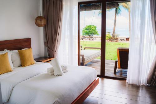 Postel nebo postele na pokoji v ubytování Woody's Place Siargao