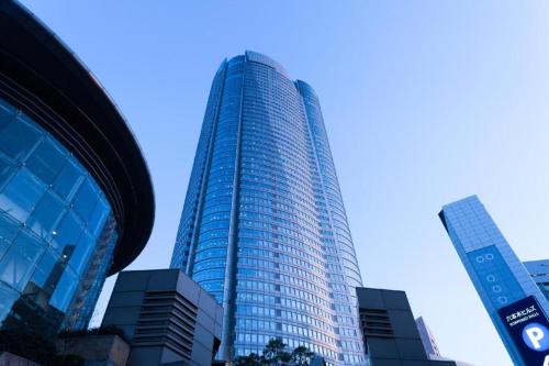 a tall building with many windows in a city at Hotel Ann Tsukiji in Tokyo