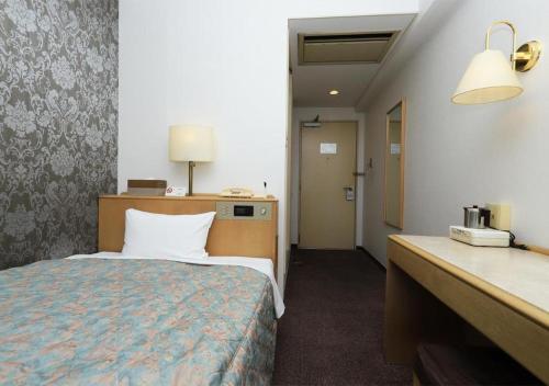 Giường trong phòng chung tại Kawagoe Dai-ichi Hotel