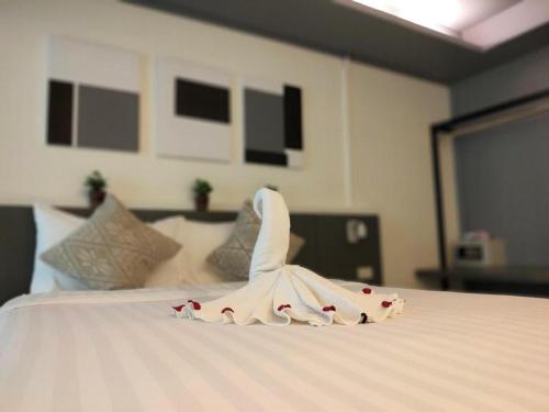 a robe on top of a bed in a room at Silom Studios in Bangkok