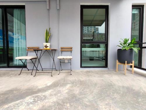 a patio with chairs and a table on a building at Silom Studios in Bangkok