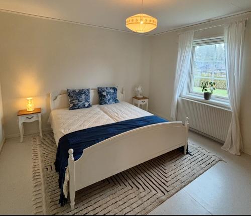 a bedroom with a large bed and a window at Castellet Sommer House in Uppsala