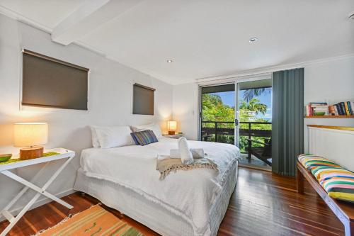 a bedroom with a bed and a large window at 1770 Horizons holiday house - pet friendly home in 1770 in Seventeen Seventy