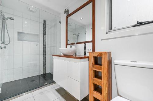 a bathroom with a sink and a toilet and a shower at 1770 Horizons holiday house - pet friendly home in 1770 in Seventeen Seventy