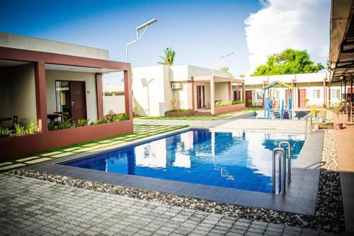 a swimming pool in front of a house at Sabine's Place in Masbate
