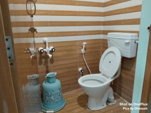 a small bathroom with a toilet and a shower at Annamaiah Premium & Grand - 2 & 3 BHK Apartments for Families - Homestay & Home Food Service in Tirupati