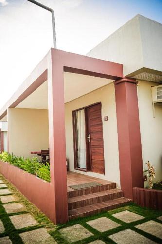 a house with a porch and stairs in front of it at Sabine's Place in Masbate