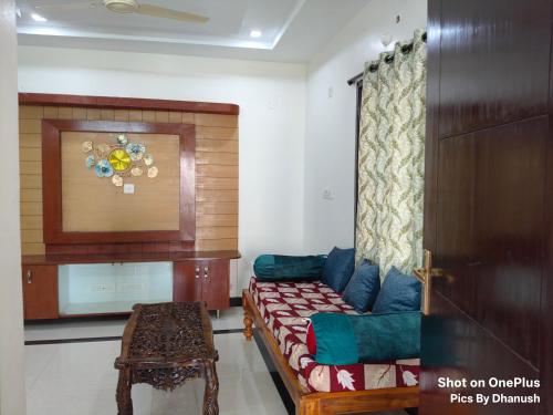 a living room with a couch and a table at Annamaiah Premium & Grand - 2 & 3 BHK Apartments for Families - Homestay & Home Food Service in Tirupati