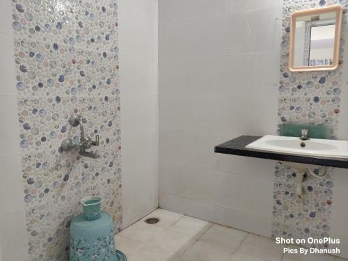 a bathroom with a sink and a toilet at Annamaiah Premium & Grand - 2 & 3 BHK Apartments for Families - Homestay & Home Food Service in Tirupati