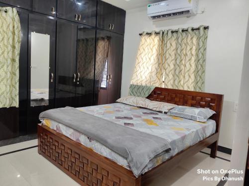 a bedroom with a bed in a room at Annamaiah Premium & Grand - 2 & 3 BHK Apartments for Families - Homestay & Home Food Service in Tirupati