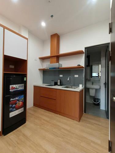 a kitchen with a sink and a counter top at Ami Apartment Hà Nội in Hanoi