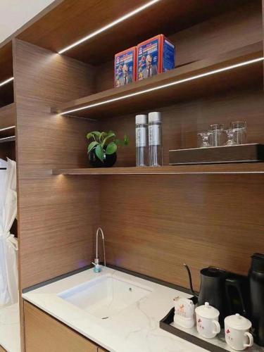 a kitchen with a sink on a wooden wall at Chaozhou Hotel in Chaozhou