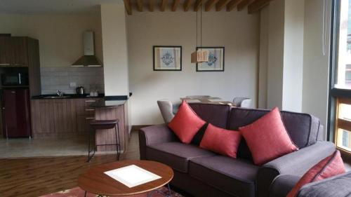 a living room with a couch and a table at The Pema by Realm in Thimphu