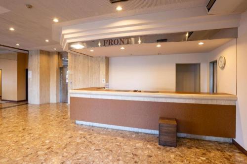 a lobby with a reception desk in a building at Tabist Hotel New Osamura Sabae in Fukui