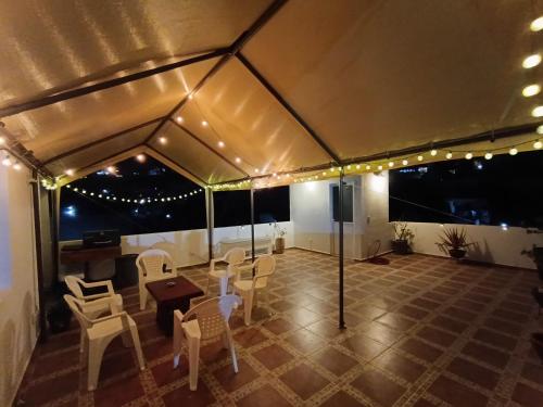 a tent with chairs and a table and lights at Apartment with private entrance and access to roof-garden in Juriquilla