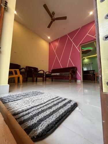 a living room with a black and white rug on the floor at Rest & Relax Resort in Yelagiri