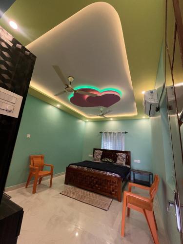 a bedroom with a bed with a chili pepper painted on the ceiling at Rest & Relax Resort in Yelagiri