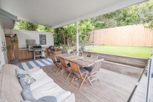 a patio with a wooden table and chairs at Relaxing Retreat in Terrigal in Terrigal