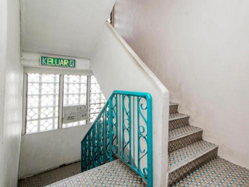 a staircase in a building with a sign that reads kulum at OYO 89706 To-day Hotel in Sibu