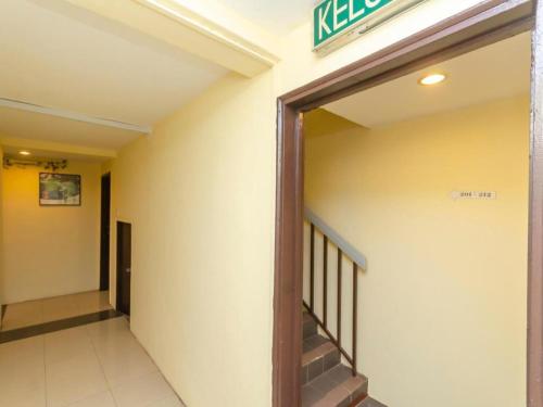 a hallway of a building with a exit sign at OYO 89703 B Link Hotel in Johor Bahru